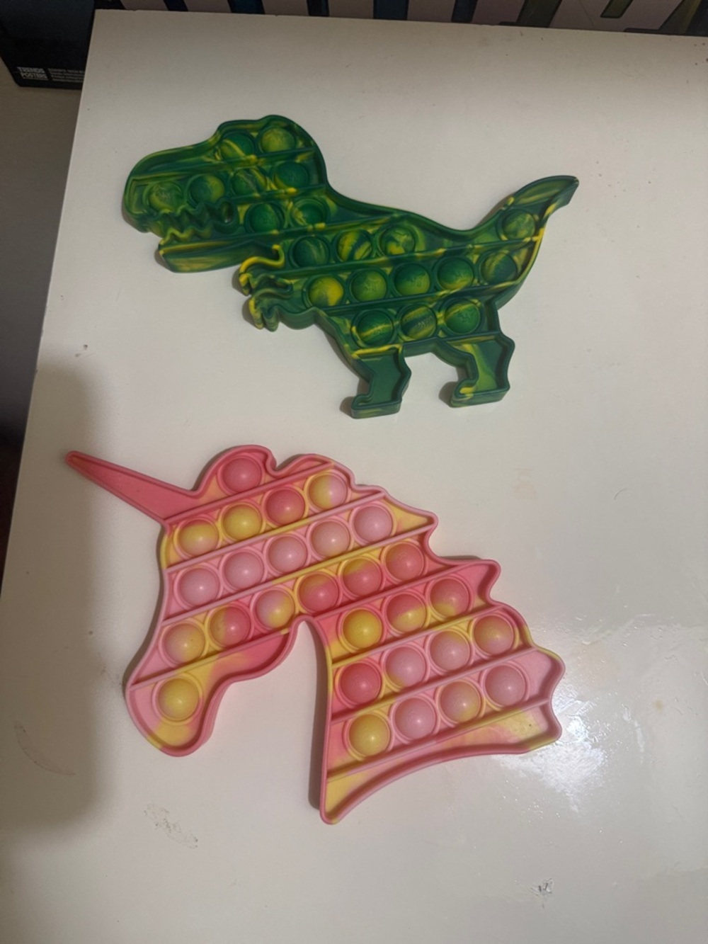 Unicorn and dinosaur pop it’s